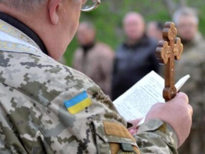 капелан на службі читає книгу