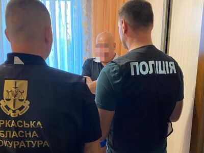 двоє правоохоронців вручають підозру