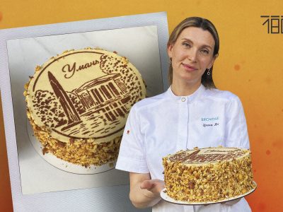 жінка з тортом на оранжевому фоні